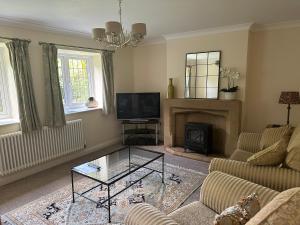 a living room with a couch and a fireplace at Scalby Grove Cottage in Scarborough