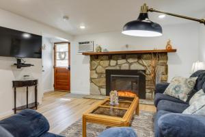 a living room with a fireplace and blue couches at Quakertown Vacation Rental Close to Hiking Trails in Quakertown