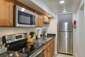 a kitchen with a stainless steel refrigerator and wooden cabinets at Quakertown Vacation Rental Close to Hiking Trails in Quakertown