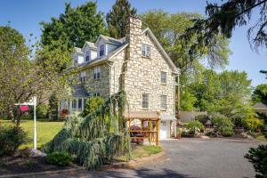 a stone house with a gate in front of it at Quakertown Vacation Rental Close to Hiking Trails in Quakertown