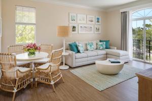 a living room with a couch and a table at The Capri Inn in Naples