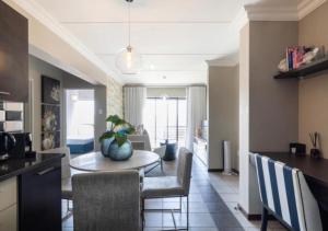 ヨハネスブルグにあるThe Steynview Apartment - Fourways Sandtonのテーブルと椅子のあるキッチンとリビングルーム