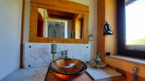 a bathroom with a bowl sink on a counter at Domalek pod Złotym Kogutem in Kudowa-Zdrój