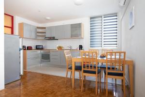 a kitchen with a table and chairs and a refrigerator at Apartment LilyM in Rovinj