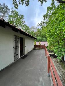 a building with a porch and a fence at Austeria Przyjezierze in Pojezierze