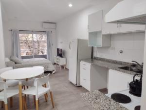a kitchen and living room with a table and a room at DTo CÉNTRICO LOBOS 1 B in Lobos
