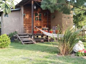 a house with a hammock in front of it at Temazcal Casa de Barro in San Juan Teotihuacán