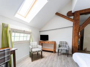 een slaapkamer met een bed, een bureau en een tv bij Farmhouse with terrace in Montfoort in Montfoort