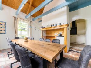 蒙特福特的住宿－Spacious holiday home in Montfoort with private terrace，一间带木桌和椅子的用餐室