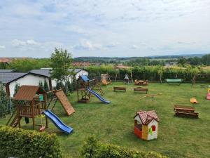 a yard with a playground with a slide and swings at Cozy holiday homes near the beach in Jaros awiec in Jarosławiec