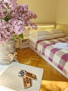 a bedroom with a bed and a table with a key at Villa ZENKO in Lviv