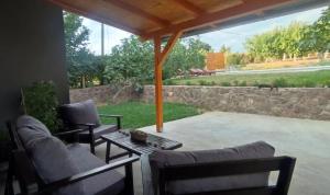 a patio with two couches and a table at Boom House Fruska Gora in Irig