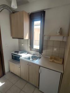 a small kitchen with a sink and a stove at Angelo Studios in Nikiti