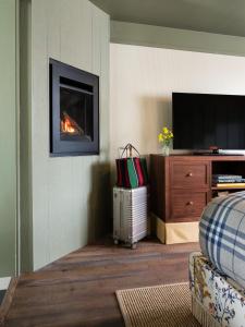 a living room with a fireplace and a television at Le Petit Pali at Ocean Ave in Carmel