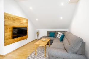 a living room with a couch and a table at Apartman Medved in Slunj