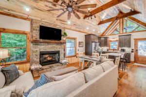 a living room with a couch and a fireplace at Brand New Build Luxury Mountain Chalet with Hot tub, pool, Game Room, Premium features in Ellijay