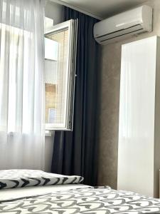 a bedroom with a bed and a window at Apartment Aurora in Foča +2 photos