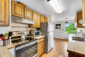 a kitchen with wooden cabinets and a stainless steel refrigerator at Blanco Style in Poulsbo
