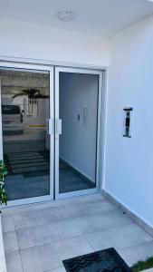 an entrance to a building with sliding glass doors at Luxurious 2 bedroom apartment with pool in Punta Cana