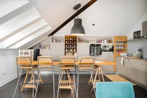 a kitchen with a wooden table and chairs at Vila Ava in Zaprešić