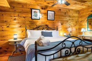 a bedroom with a bed in a wooden wall at Pet-Friendly, Views, Hot Tub, WIFI, Game Room in Sevierville