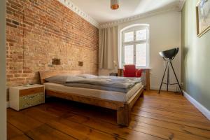 a bedroom with a bed and a brick wall at The Good Place in Kreuzberg Berlin in Berlin