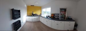 a kitchen with white cabinets and a counter with a window at Balanced Rock Inn in Fruita