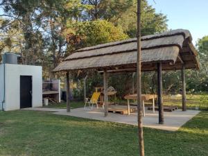 a wooden pavilion with a table and a bench at CAMPING DON EMILIO in Lobos