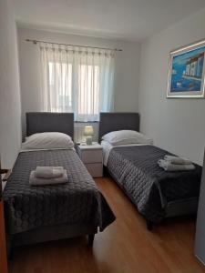Posteľ alebo postele v izbe v ubytovaní Apartments Lorena