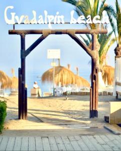 an entrance to a beach with a sign on it at Incredible luxury location Banús beach for families in Marbella