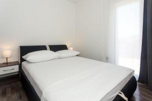 Postel nebo postele na pokoji v ubytování Angolo Apartments