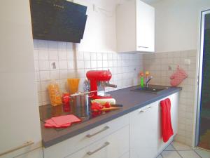 a kitchen counter with a red mixer on it at Ferienwohnung Das Inge die Oberne in Bernau in Bernau am Chiemsee +15 photos