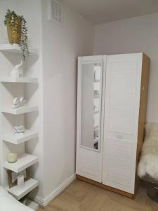 a room with white shelves and a white cabinet at 2 Bedroom Flat in Vauxhall, London in London