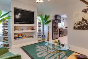 a living room with a glass table and a tv at Modern Oklahoma City Home with Private Backyard! in Oklahoma City