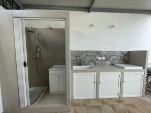 a bathroom with white cabinets and a shower and a sink at Il mare di Totino - Seaside guest house - Torre San Giovanni in Torre San Giovanni Ugento