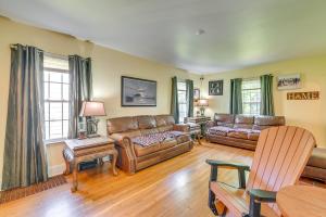 a living room with leather couches and a table at Pet-Friendly Gloversville Cottage Near Golf Course in Gloversville