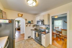 a kitchen with a stove and a refrigerator at Pet-Friendly Gloversville Cottage Near Golf Course in Gloversville