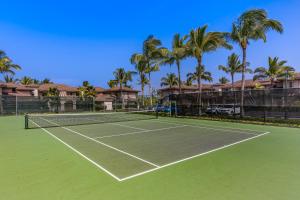 a tennis court with palm trees in the background at Waikoloa Colony Villas 1703 in Waikoloa