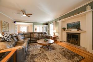 a living room with a couch and a fireplace at Inviting Colorado Springs House with Spacious Deck! in Colorado Springs