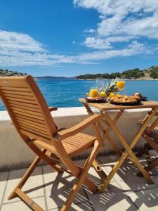 a wooden patio table with a plate of food on it at Sea Star in Tribunj