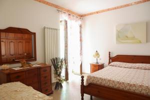 A bed or beds in a room at Il Mosaico Al Mare