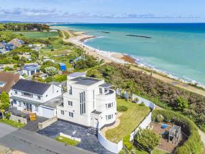 an aerial view of a white house and the ocean at Three Decks in Yapton