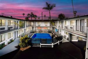 an aerial view of a building with a swimming pool at Sunset West Hotel, SureStay Collection By Best Western in Los Angeles