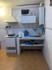 a kitchen with a sink and a microwave at Cassanova III in San Luis