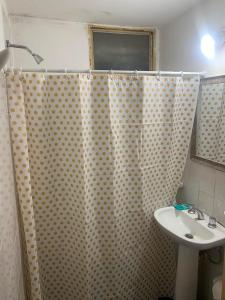 a bathroom with a shower curtain and a sink at Cassanova III in San Luis