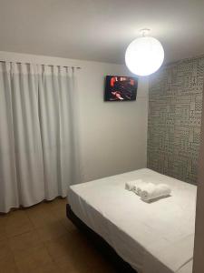 a bedroom with a bed with white towels on it at Cassanova III in San Luis