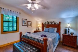 a bedroom with a bed and a ceiling fan at Amberwood- Get 951 worth of FREE area attraction tickets for each paid day!!! in Sevierville