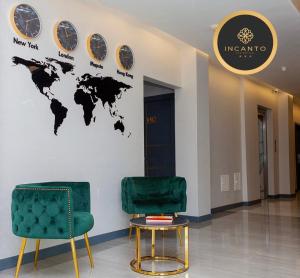 two chairs in a lobby with a map of the world on the wall at INCANTO RESIDENCIAL in Maputo