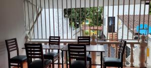 a dining room with a table and chairs and a balcony at Aparta Hotel el Castillo in Melgar