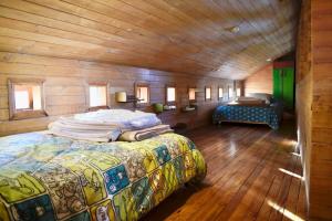 ein Schlafzimmer mit einem großen Bett in einem Holzzimmer in der Unterkunft Refugio Arquitectónico frente al Mar in Ancud
